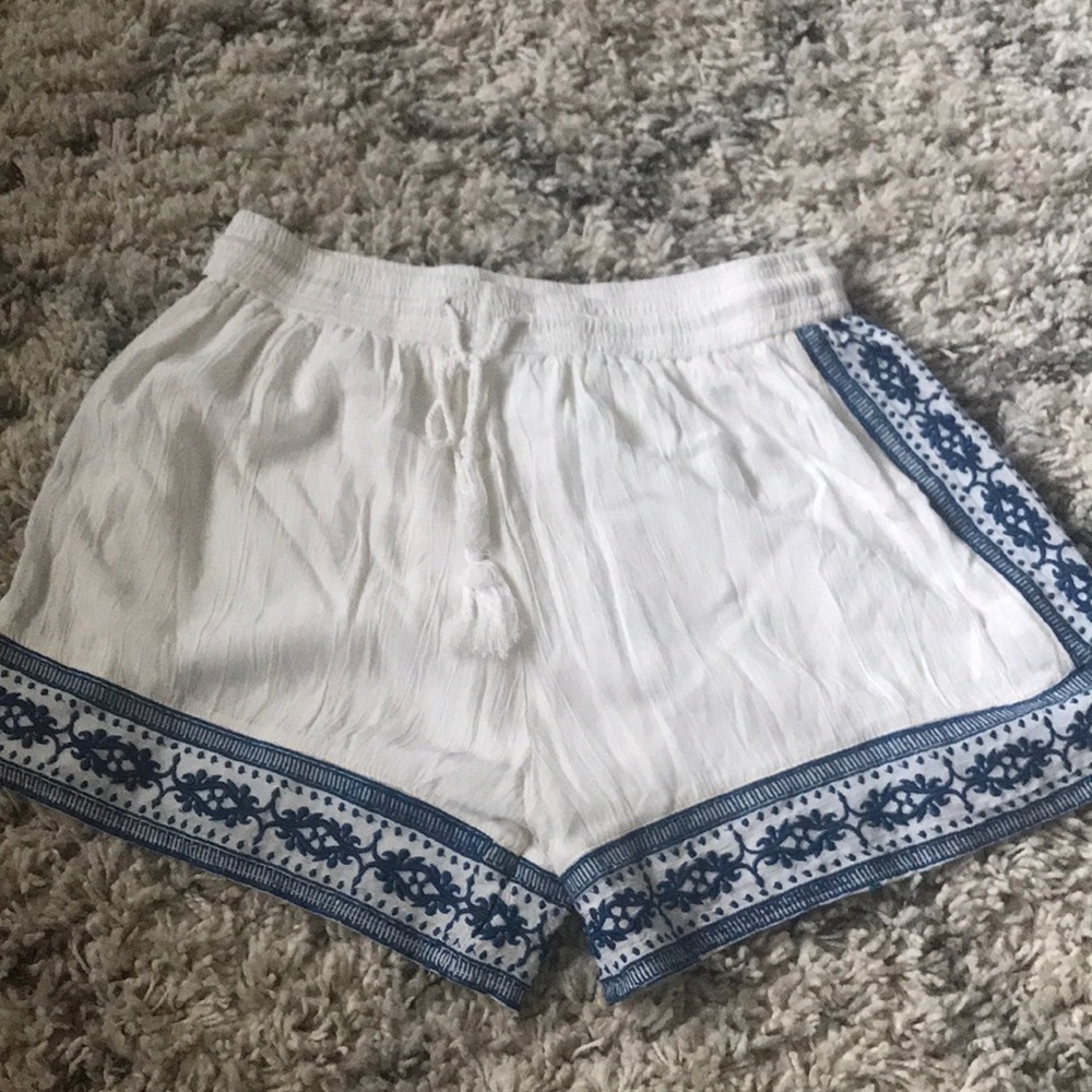 White shorts with blue embroidery detail